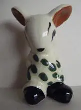 White ceramic rabbit with green spots.