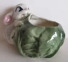 White rabbit ceramic planter with green cabbage.