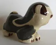 Ceramic figurine of a gray and white dog.