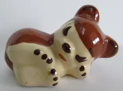 Ceramic figurine of a sleeping bear.