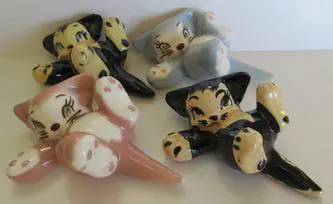 Four ceramic kittens in various colors.