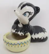 Black and white skunk figurine with pot.