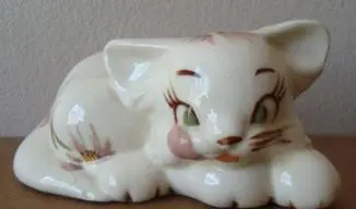 White porcelain kitten figurine with floral design.