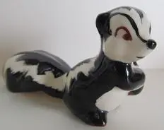 Black and white ceramic skunk figurine.