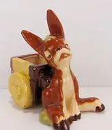 Ceramic donkey pulling a miniature wagon.