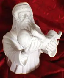 White porcelain sculpture of a man holding a baby.