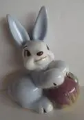 Ceramic blue bunny holding an egg.