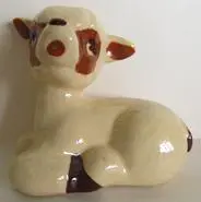 Ceramic figurine of a brown and white lamb.