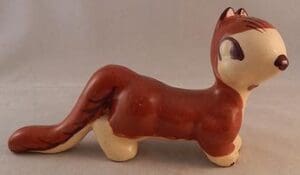 Brown and white ceramic squirrel figurine.