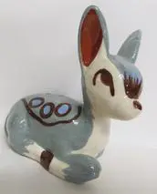 Ceramic fawn figurine with blue and brown accents.