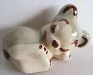 Ceramic figurine of a sleeping koala.