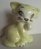 A yellow ceramic figurine of a kitten.