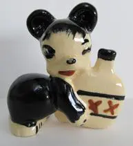 Black and white ceramic bear with a bottle.