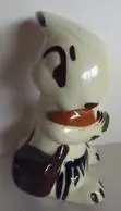 Ceramic figurine of a cat eating a carrot.