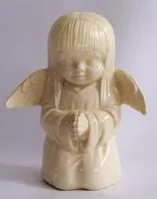 White porcelain figurine of a praying angel.