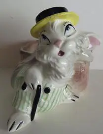 Ceramic rabbit planter with hat and cane.