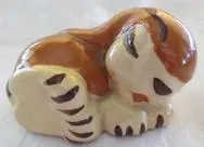 A small ceramic figurine of a tiger cub.