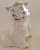 White porcelain figurine of a cat.