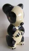 Black and white ceramic panda figurine.