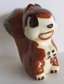 Brown and white ceramic squirrel figurine.