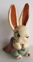 White ceramic rabbit holding a carrot.