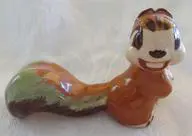 Ceramic figurine of a smiling squirrel.