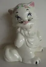 White ceramic cat figurine with pink ears.