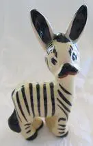 Ceramic figurine of a black and white zebra.