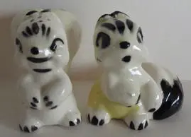 Two ceramic figurines of a bunny and a cat.