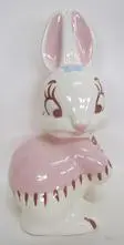 White ceramic bunny figurine wearing pink dress.