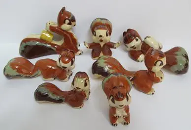 Ceramic squirrel figurines in various poses.