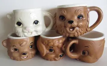 Five animal-shaped ceramic mugs.