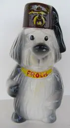 Ceramic dog figurine wearing a fez.