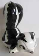 Black and white ceramic skunk figurine.