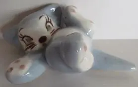 A blue and white ceramic cat figurine.