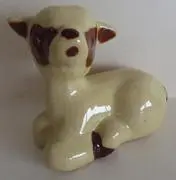 Ceramic figurine of a brown and white lamb.