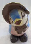 Ceramic figurine of a man in a hat.