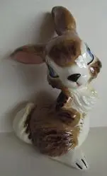 Brown and white ceramic rabbit figurine.