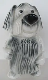 White dog figurine with "Ford" on collar.