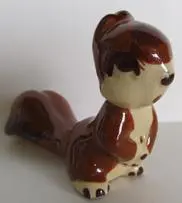 Brown and white ceramic squirrel figurine.