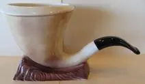 Ceramic pipe shaped vase with black stem.