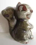 Ceramic figurine of a smiling squirrel.