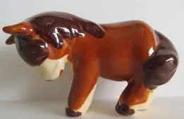 Brown and white ceramic horse figurine.