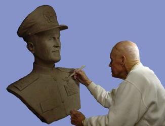 Sculptor working on a clay bust.