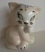 A white porcelain figurine of a cat.