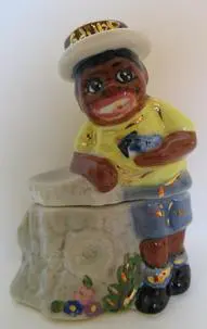 A ceramic figurine of a man with a hat.