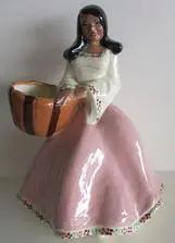 Ceramic figurine of a woman with a basket.