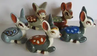 Five colorful ceramic deer figurines.