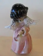 Ceramic angel figurine with black hair.