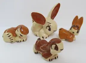 Set of four ceramic bunny figurines.